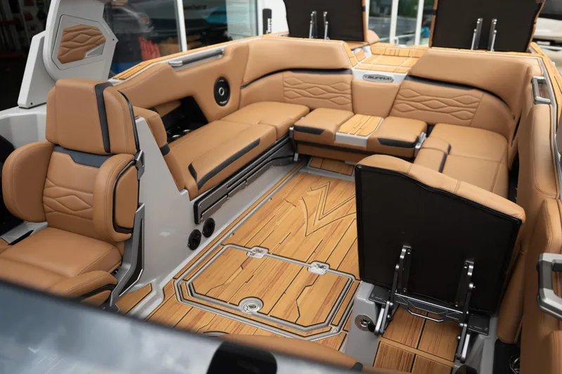 Slide: The Image of Luxurious interior of 2025 Supra SE 550 boat with tan leather seating and wood flooring. - 30