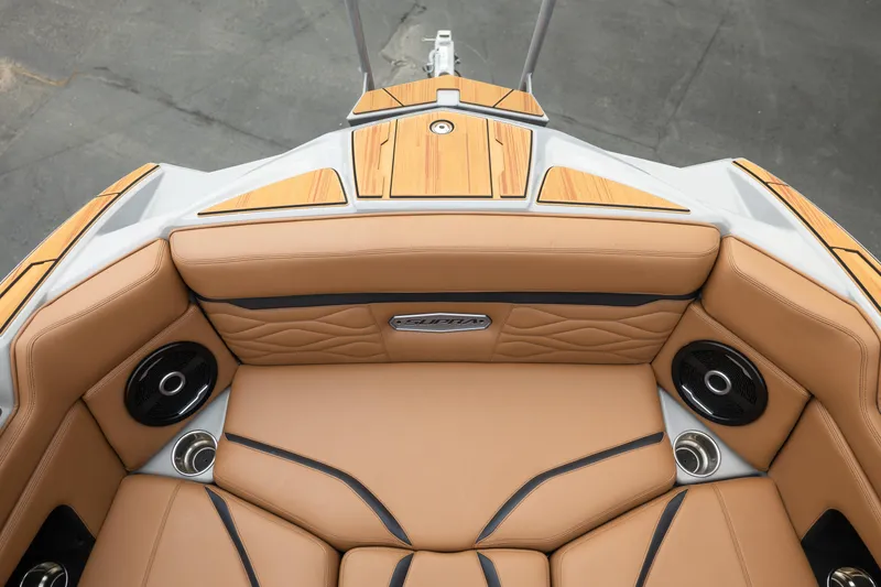 Slide: The Image of 2025 Supra SE 550 boat interior with tan leather seats and integrated speakers. - 32