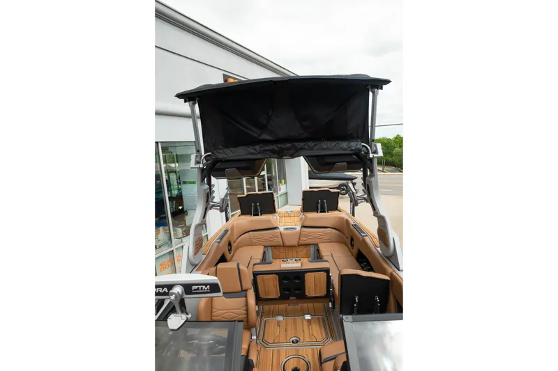 Slide: The Image of 2025 Supra SE 550 boat interior with tan leather seating and black canopy. - 34