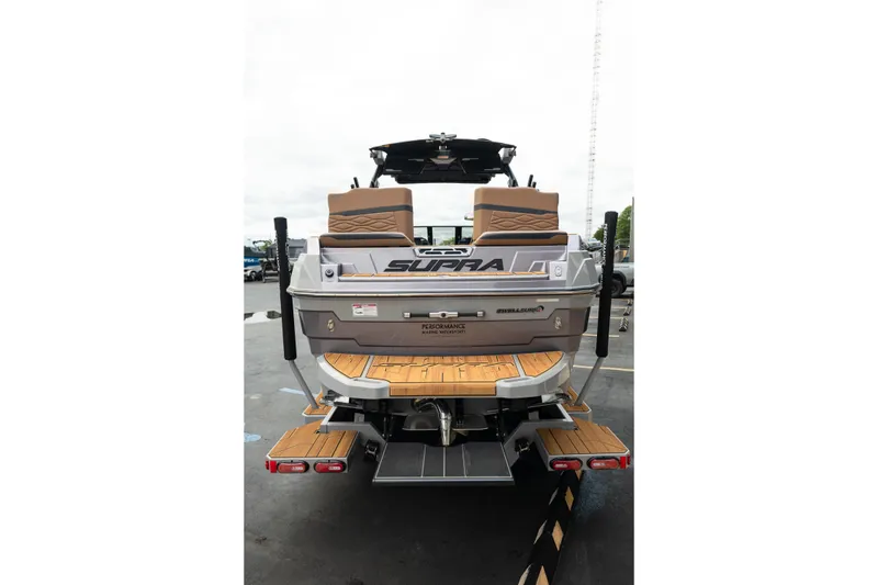 Slide: The Image of 2025 Supra SE 550 boat rear view with teak swim platform and seating. - 9