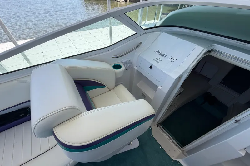 Slide: The Image of Interior of 2004 Envision 3200 Intruder boat with white seating and cabin entrance. - 10