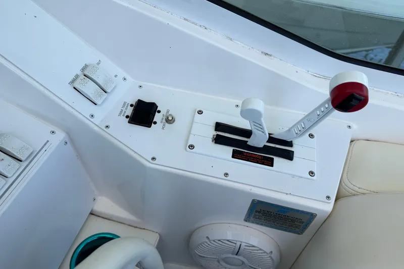 Slide: The Image of Control panel of a 2004 Envision 3200 Intruder boat with throttle and switches. - 13