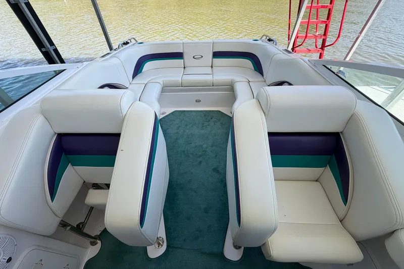 Slide: The Image of Interior of 2004 Envision 3200 Intruder boat with white and teal seating. - 14