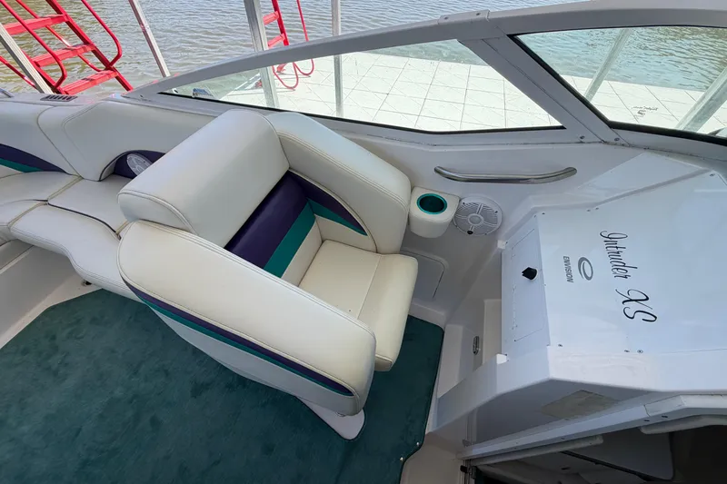 Slide: The Image of Interior of 2004 Envision 3200 Intruder boat with white and teal seating. - 15