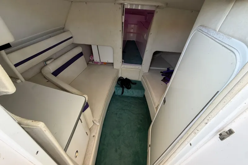 Slide: The Image of Interior of a 2004 Envision 3200 Intruder boat with seating and storage. - 16