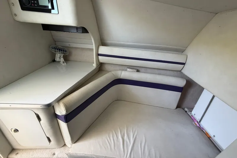 Slide: The Image of Interior of 2004 Envision 3200 Intruder boat with seating and small desk area. - 19