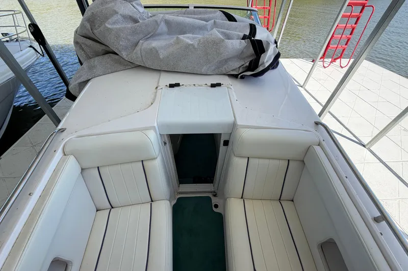 Slide: The Image of 2004 Envision 3200 Intruder boat interior with white seating and covered deck. - 22