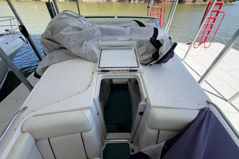 Slide: The Image of 2004 Envision 3200 Intruder boat interior with open hatch and covered seating area. - 27