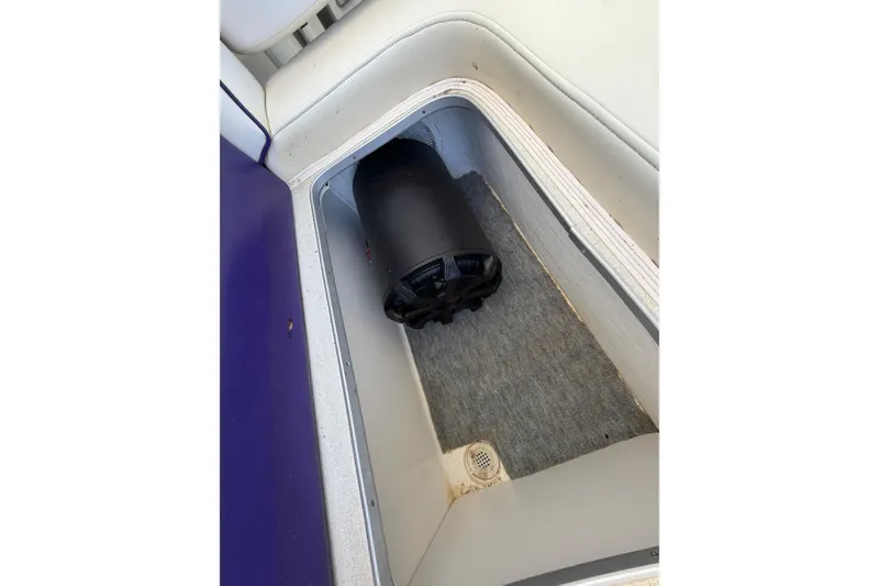 Slide: The Image of Storage compartment in a 2004 Envision 3200 Intruder boat with a black speaker. - 30