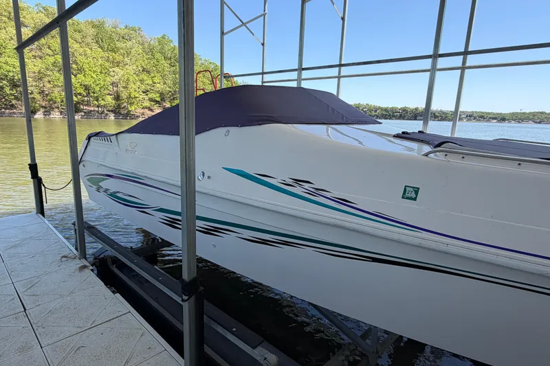 Slide: The Image of 2004 Envision 3200 Intruder boat docked on a serene lake. - 4