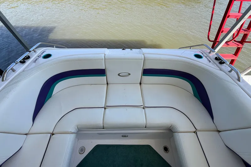 Slide: The Image of 2004 Envision 3200 Intruder boat interior with white cushioned seating and colorful accents. - 6