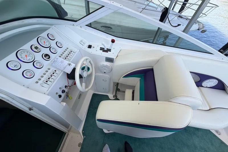 Slide: The Image of Cockpit of 2004 Envision 3200 Intruder boat with gauges and steering wheel. - 9