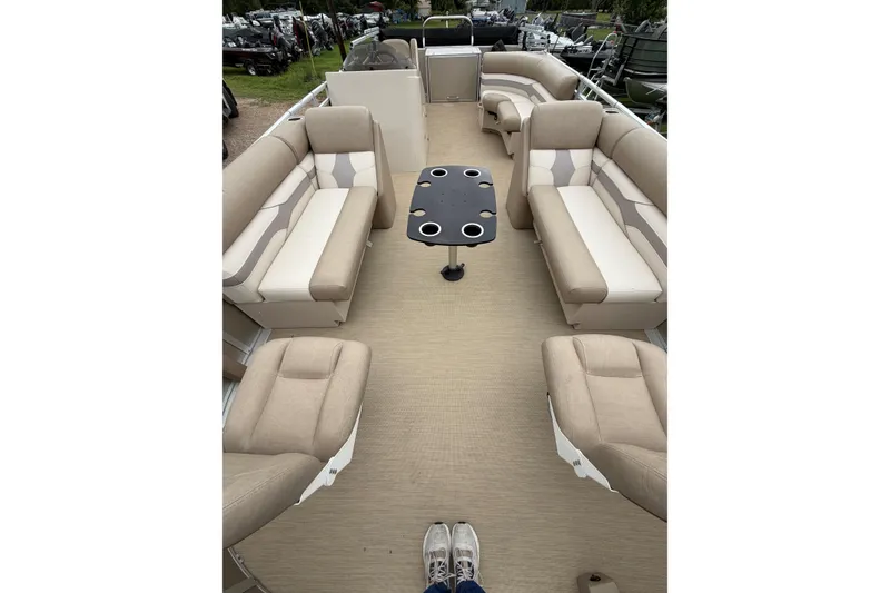 Slide: The Image of 2013 Cypress Cay Cabana 240 pontoon boat interior with beige seating and central table. - 4