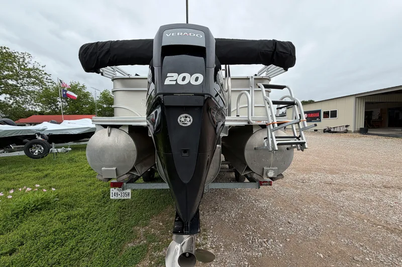 Slide: The Image of 2013 Cypress Cay Cabana 240 pontoon boat with Verado 200 engine, parked outdoors. - 6