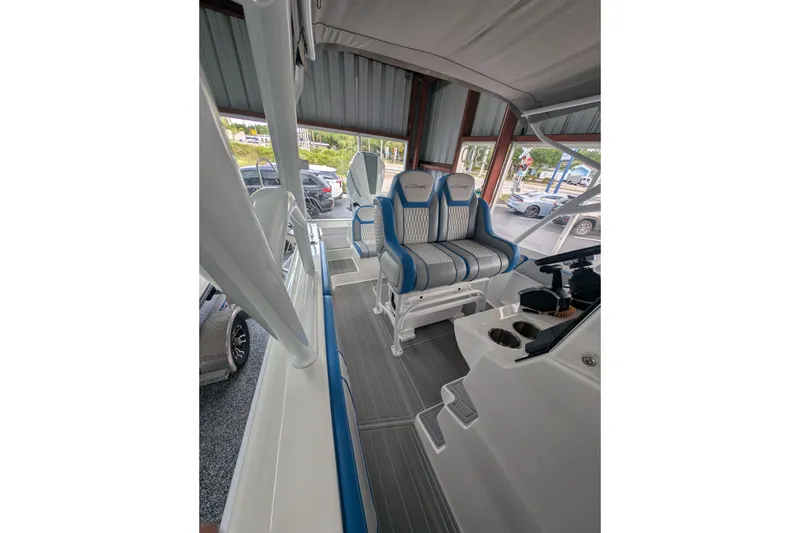 Slide: The Image of 2024 Concept 27' CC boat interior with blue and white seating, modern design. - 4
