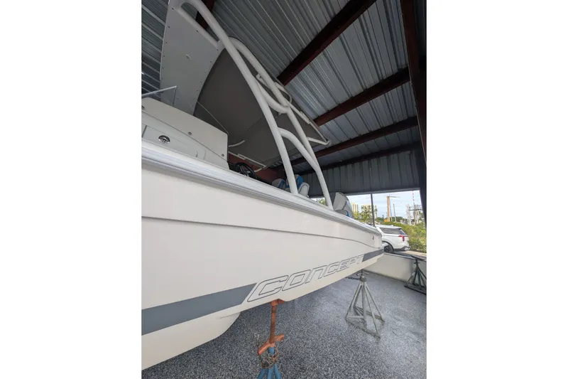 Slide: The Image of 2024 Concept 27' CC boat under a metal roof, side view. - 7