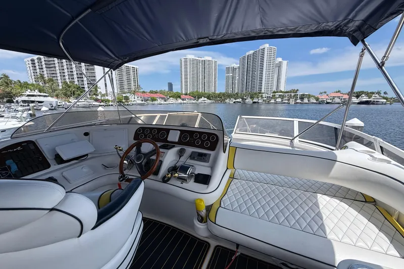 Slide: The Image of Interior view of 2001 Sea Ray 450 Express Bridge yacht with cityscape background. - 11