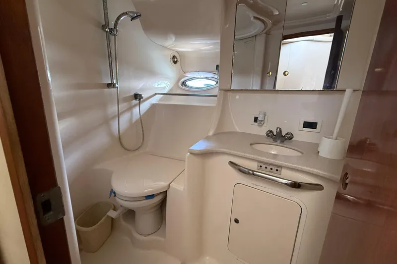 Slide: The Image of Bathroom interior of 2001 Sea Ray 450 Express Bridge yacht, featuring shower and sink. - 18