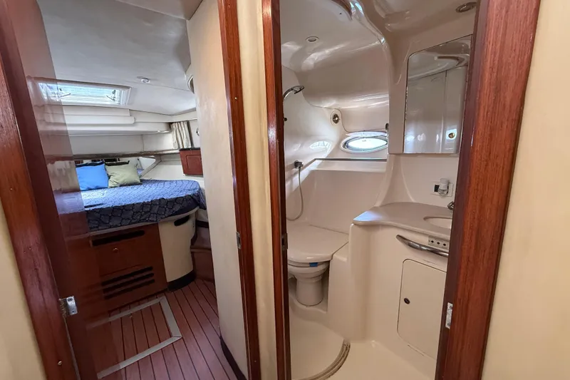 Slide: The Image of 2001 Sea Ray 450 Express Bridge interior with bedroom and bathroom view. - 21