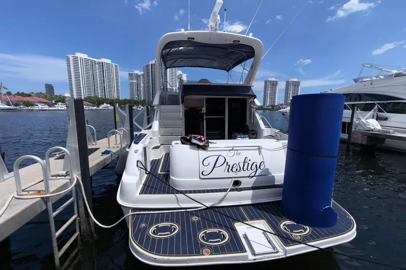Slide: The Image of 2001 Sea Ray 450 Express Bridge yacht docked at marina with city skyline. - 24