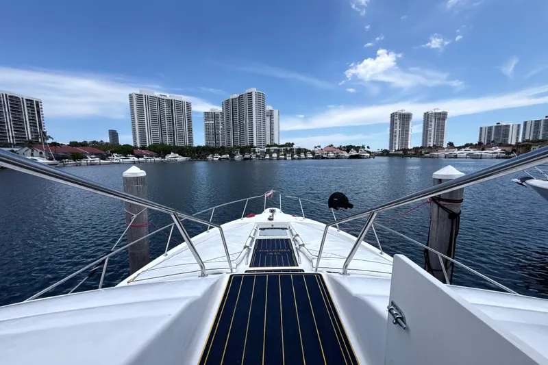 Slide: The Image of 2001 Sea Ray 450 Express Bridge docked with city skyline in the background. - 4