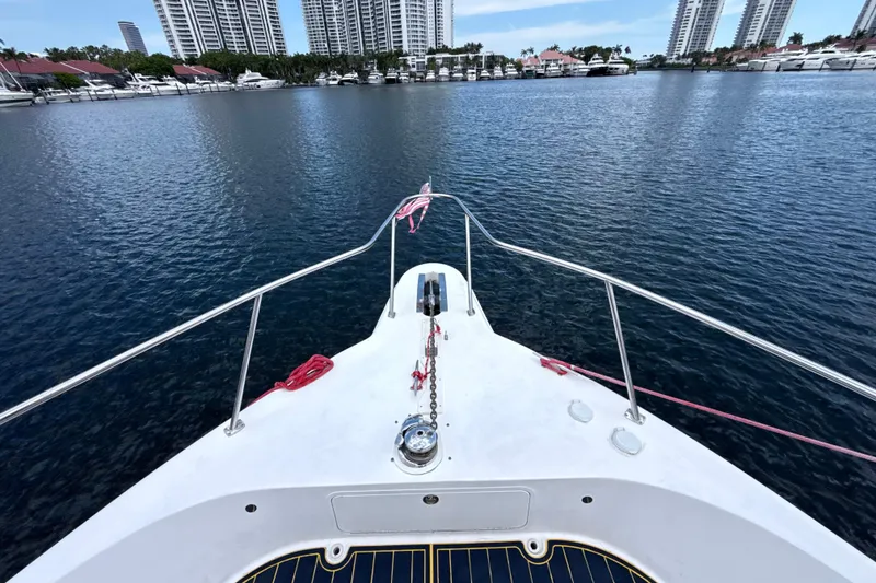 Slide: The Image of Bow view of 2001 Sea Ray 450 Express Bridge yacht in a marina setting. - 5
