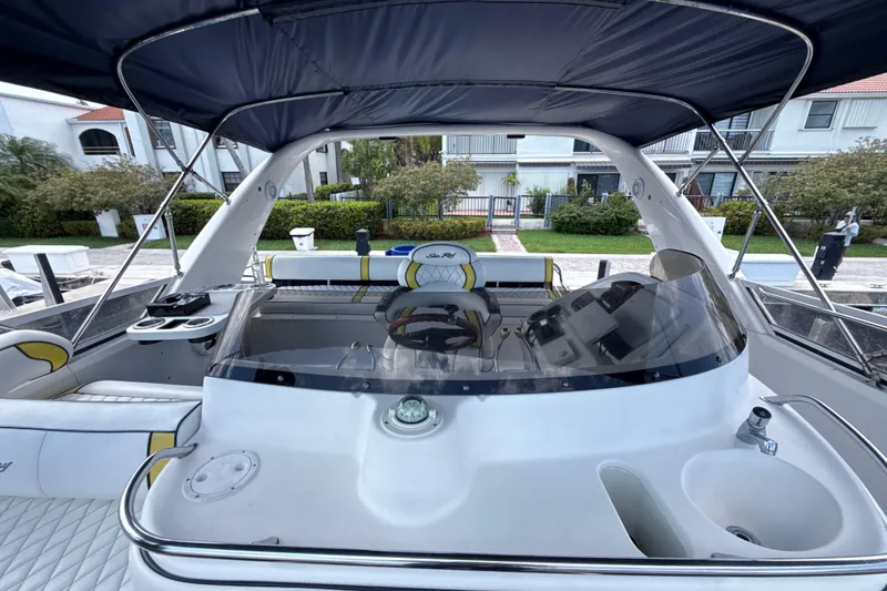 Slide: The Image of 2001 Sea Ray 450 Express Bridge yacht interior with helm, seating, and canopy. - 7