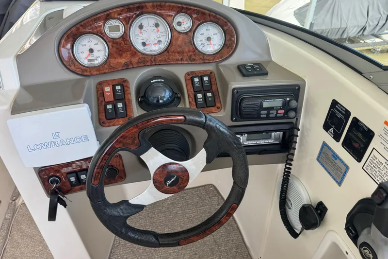 Slide: The Image of 2006 Rinker 282 Captiva Bowrider dashboard with steering wheel and control panel. - 10