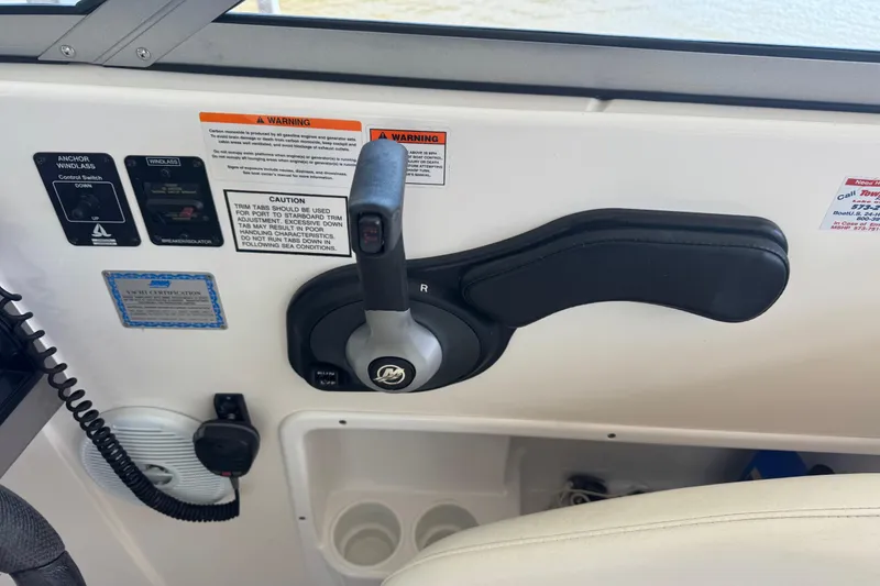 Slide: The Image of Control panel of a 2006 Rinker 282 Captiva Bowrider boat with throttle lever. - 11