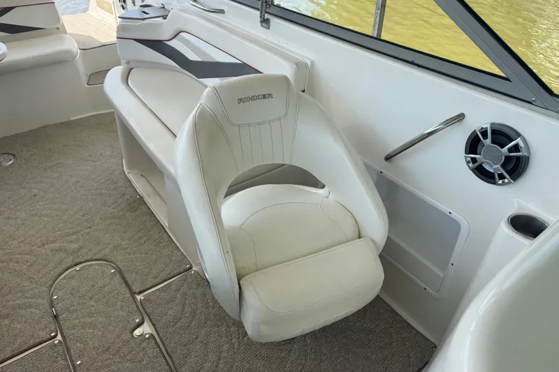 Slide: The Image of 2006 Rinker 282 Captiva Bowrider interior with white seating and carpeted flooring. - 12