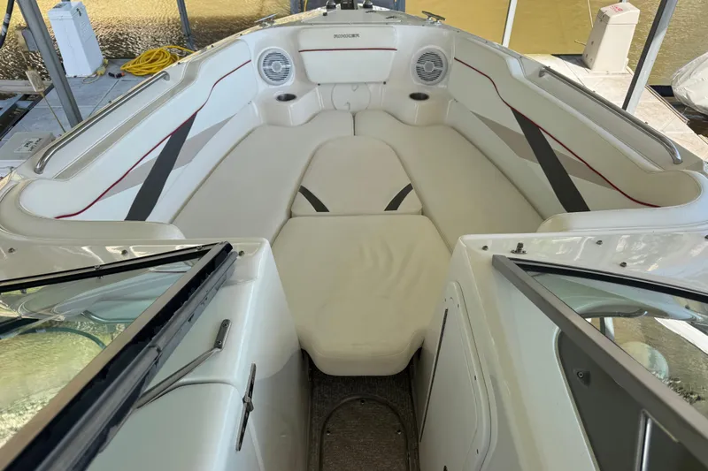 Slide: The Image of 2006 Rinker 282 Captiva Bowrider interior with white seating and speaker system. - 13