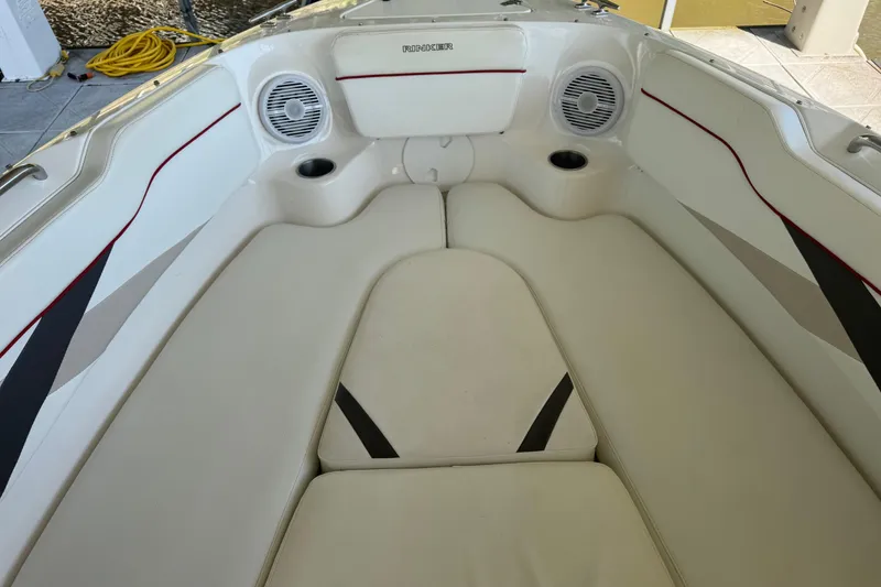 Slide: The Image of 2006 Rinker 282 Captiva Bowrider interior with cushioned seating and built-in speakers. - 14