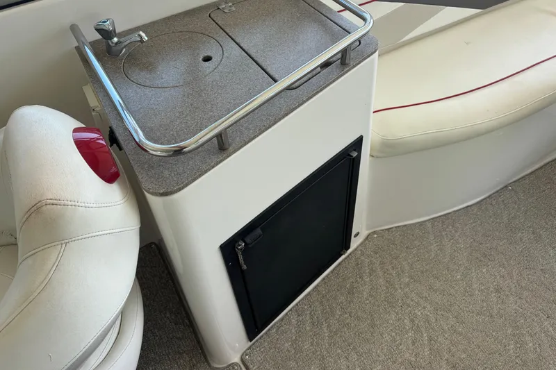 Slide: The Image of 2006 Rinker 282 Captiva Bowrider interior with sink and seating area. - 19