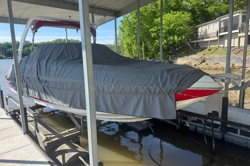 Slide: The Image of Covered 2006 Rinker 282 Captiva Bowrider docked by a lakeside. - 25