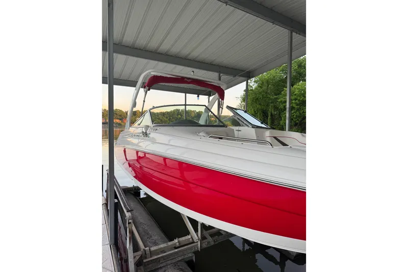 Slide: The Image of 2006 Rinker 282 Captiva Bowrider in dock, featuring red and white design. - 26