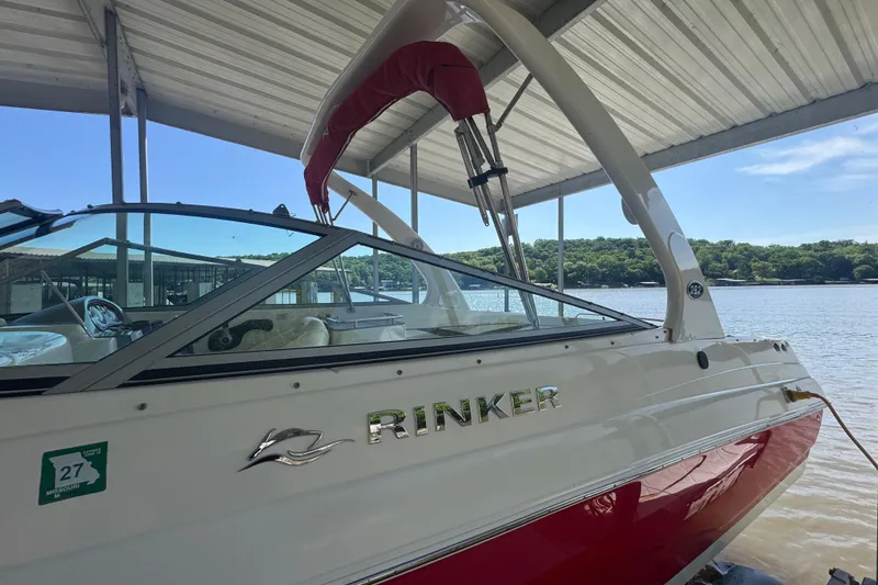Slide: The Image of 2006 Rinker 282 Captiva Bowrider docked under a covered marina. - 4