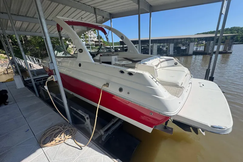 Slide: The Image of 2006 Rinker 282 Captiva Bowrider docked in a covered marina. - 5