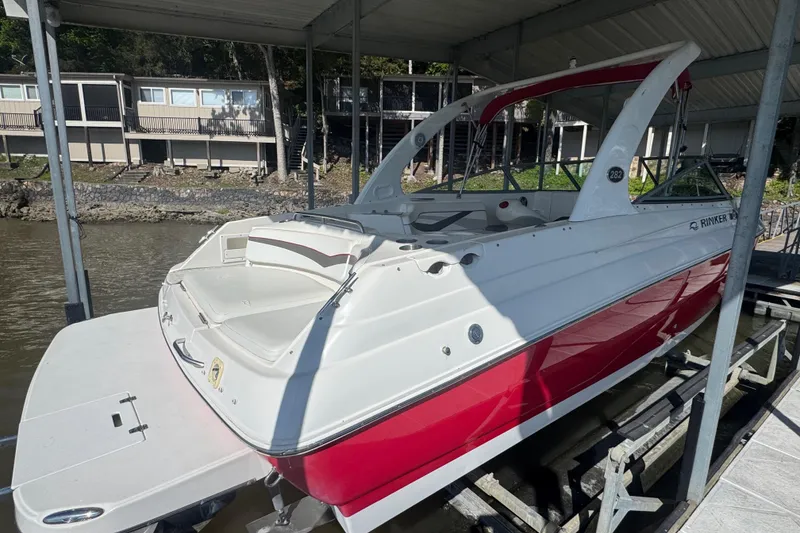 Slide: The Image of 2006 Rinker 282 Captiva Bowrider docked under a covered marina. - 6