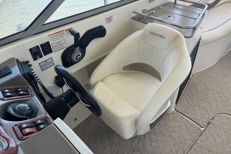 Slide: The Image of 2006 Rinker 282 Captiva Bowrider helm with steering wheel and captain's chair. - 8