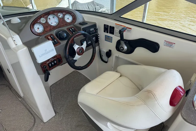 Slide: The Image of 2006 Rinker 282 Captiva Bowrider helm with steering wheel and control panel. - 9