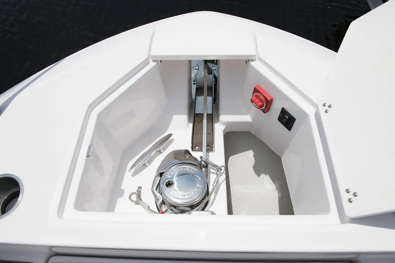 Slide: The Image of Anchor compartment of 2026 Regal 36 XO boat, featuring winch and control panel. - 13