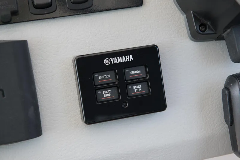 Slide: The Image of Yamaha ignition and start/stop panel on 2026 Regal 36 XO boat dashboard. - 14