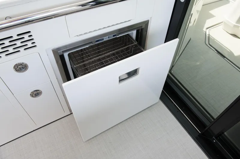 Slide: The Image of 2026 Regal 36 XO yacht interior with open drawer and sleek design. - 16