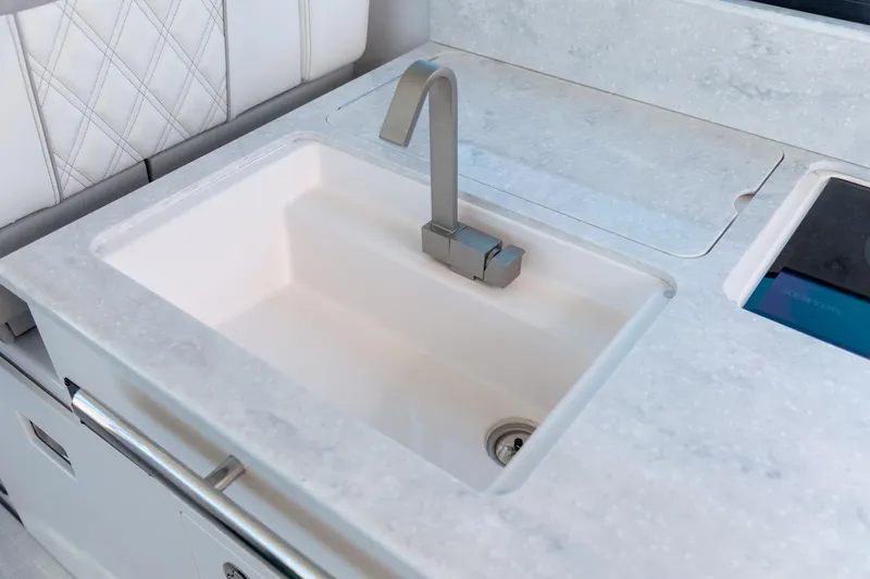 Slide: The Image of Modern sink and faucet on the 2026 Regal 36 XO yacht's sleek countertop. - 17