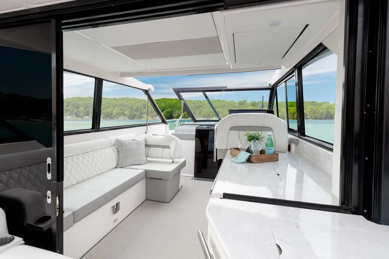 Slide: The Image of Luxurious interior of 2026 Regal 36 XO yacht with elegant seating and scenic lake view. - 18
