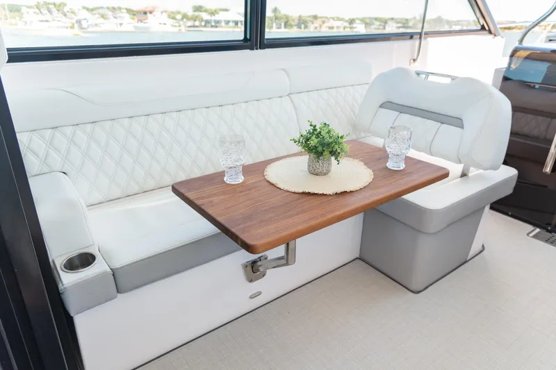 Slide: The Image of Luxurious interior of 2026 Regal 36 XO yacht with elegant seating and wooden table. - 21