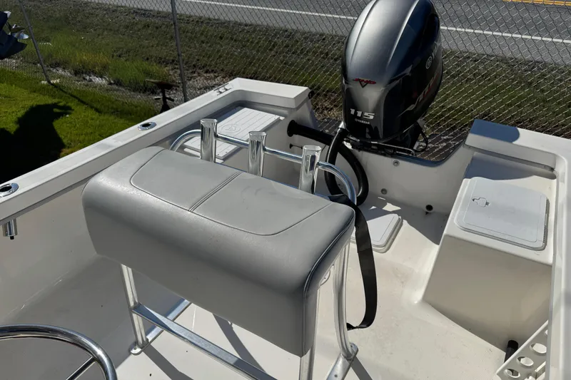 Slide: The Image of 2024 May-Craft 1900CC boat interior with Yamaha 115 engine, featuring seating and storage compartments. - 10