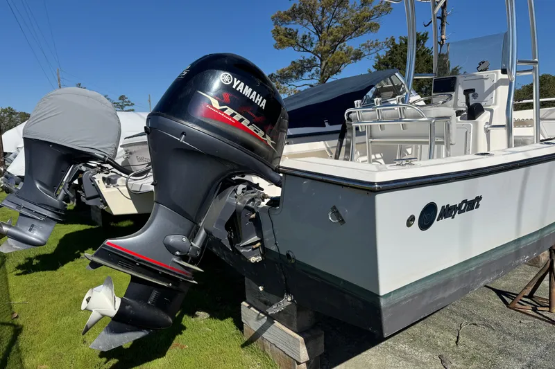 Slide: The Image of 2024 May-Craft 1900CC boat with Yamaha outboard motor, parked on grass. - 3