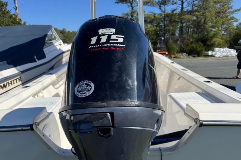 Slide: The Image of 2024 May-Craft 1900CC boat with a 115 horsepower four-stroke engine, parked outdoors. - 4