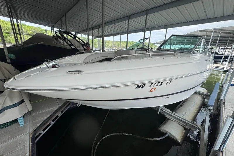 The Image of 2002 Maxum 2300 Premiere Edition boat docked in a covered marina. - 0